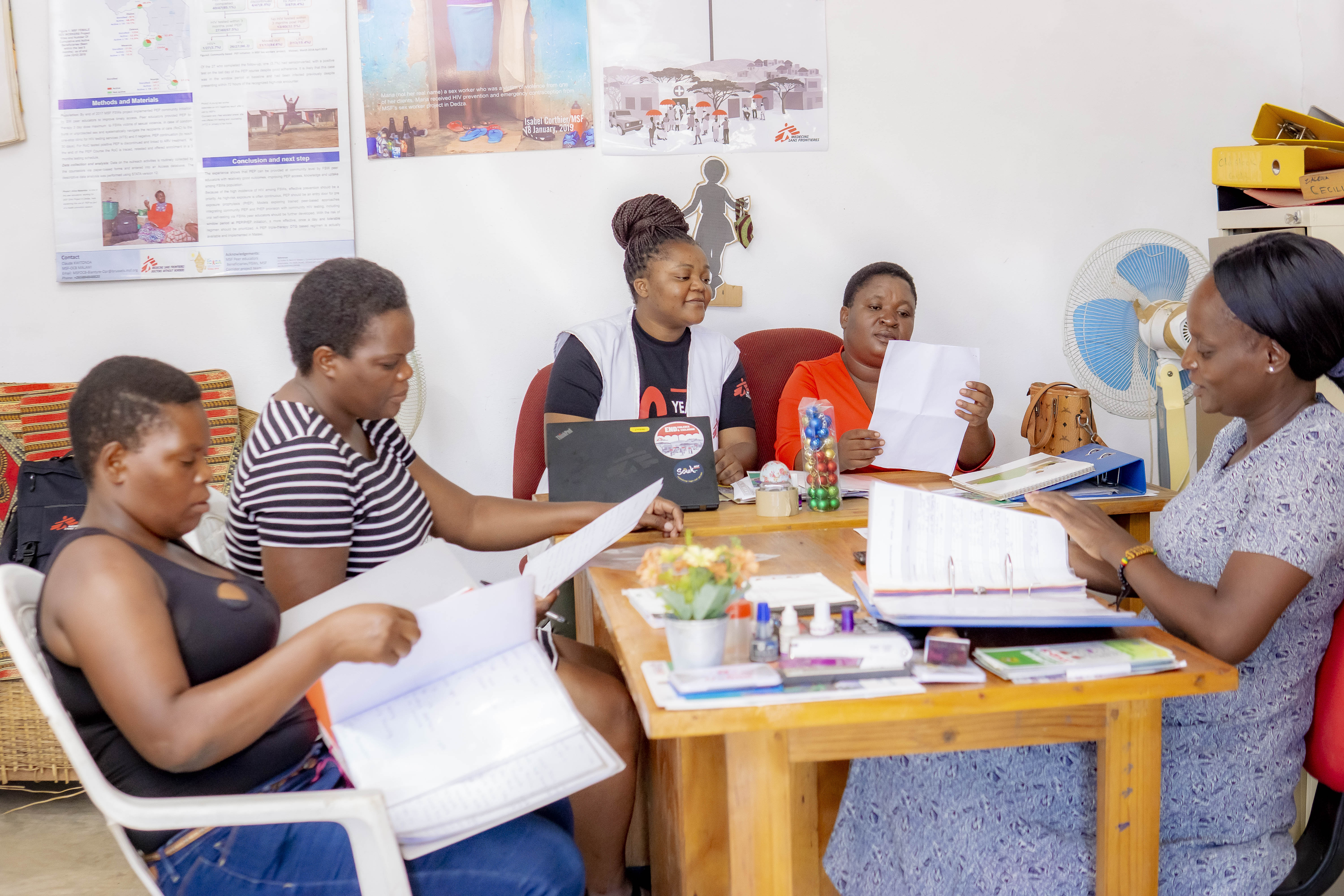 gloria_mwambazi_centre_and_msf_midwife_christine_on_her_right_meet_with_office-bearers_of_tikondane_community-based_organisation_rudo_fanny_and_cecilia_as_they_prepare_for_the_organisations_annual_activity_re.jpg